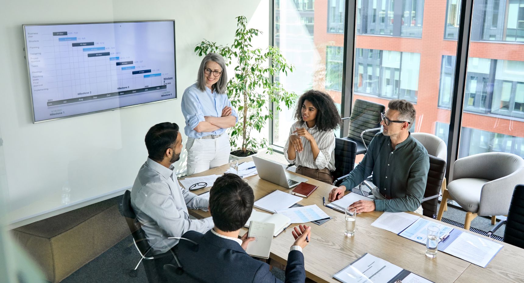 Team members collaborate in a meeting, discussing projects and strategies