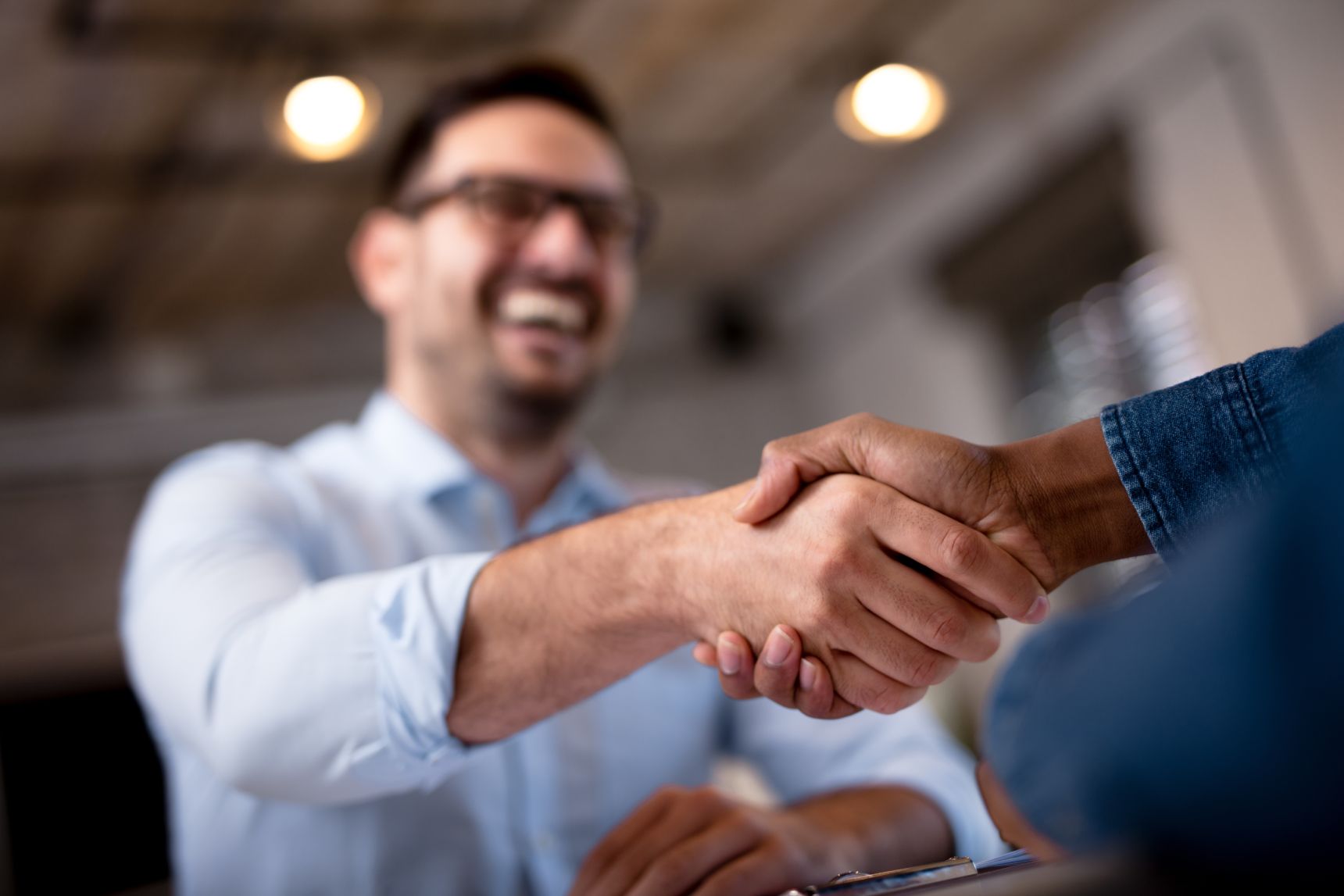 Professional handshake between businessman and client, symbolizing a successful deal